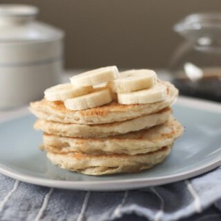 Vegan banana Sourdough Pancakes on a plate with banana slices