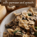 A plate of mushroom pasta with the text "Creamy mushroom pasta with parmesan and spinach"