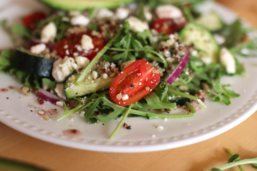 A close up look at a plate of quinoa arugula salad