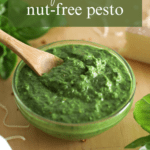 a spoon in a bowl of basil pesto