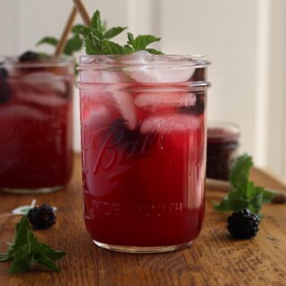 a glass of blackberry iced tea with another glass in the background