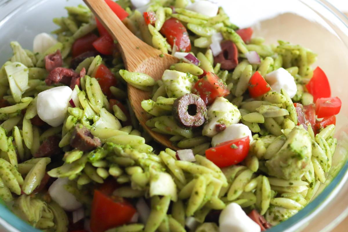 a closeup of pesto orzo pasta salad