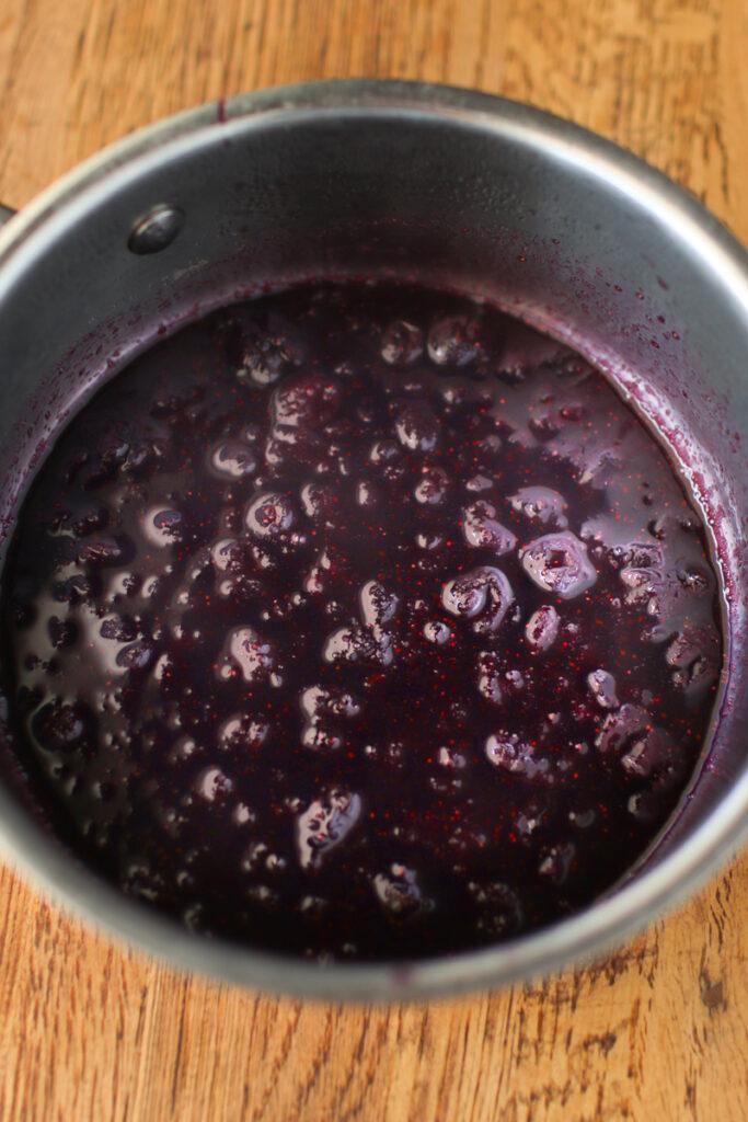 a pot of freshly made blueberry syrup