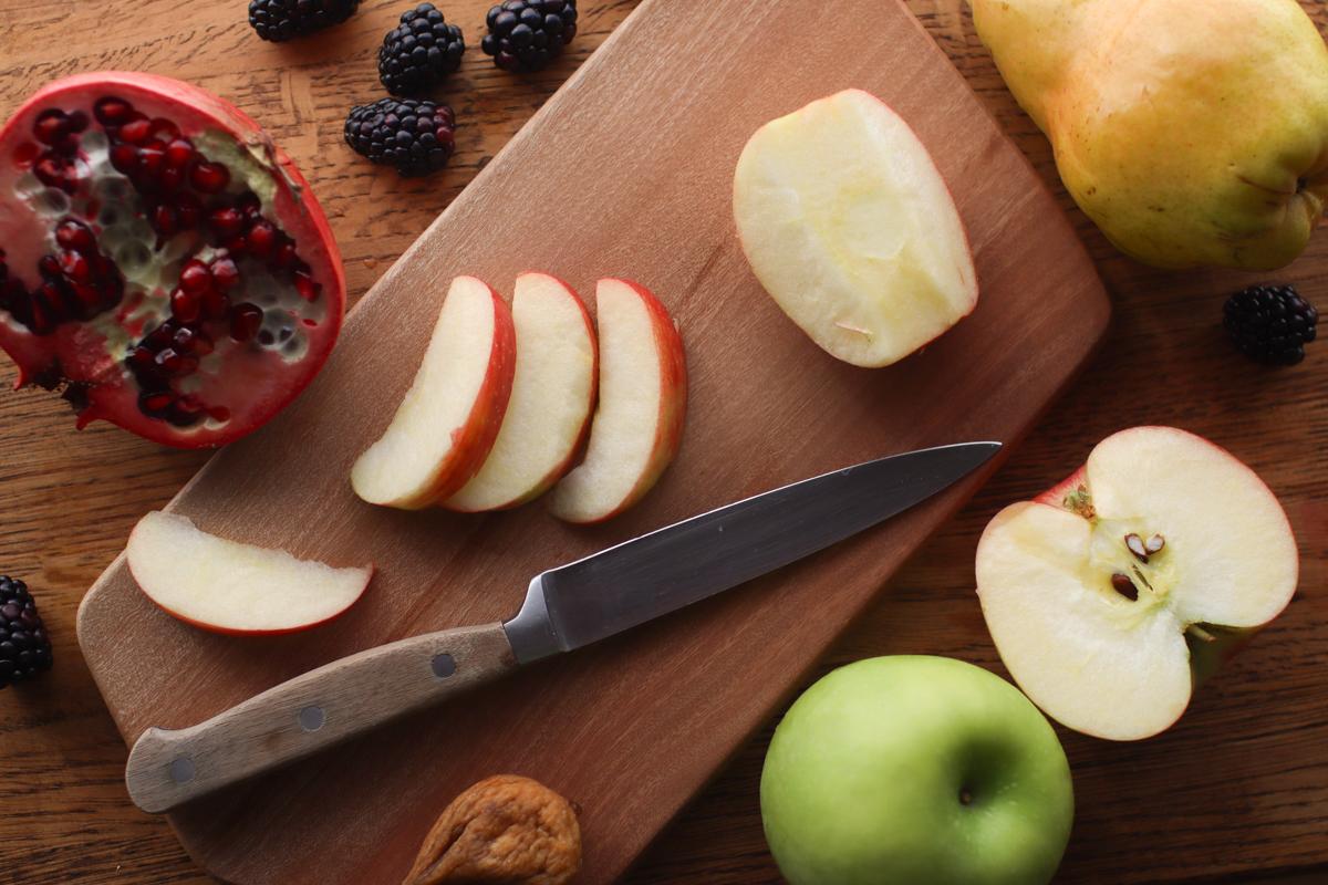 Looking down on a cutting board with a sliced apple 