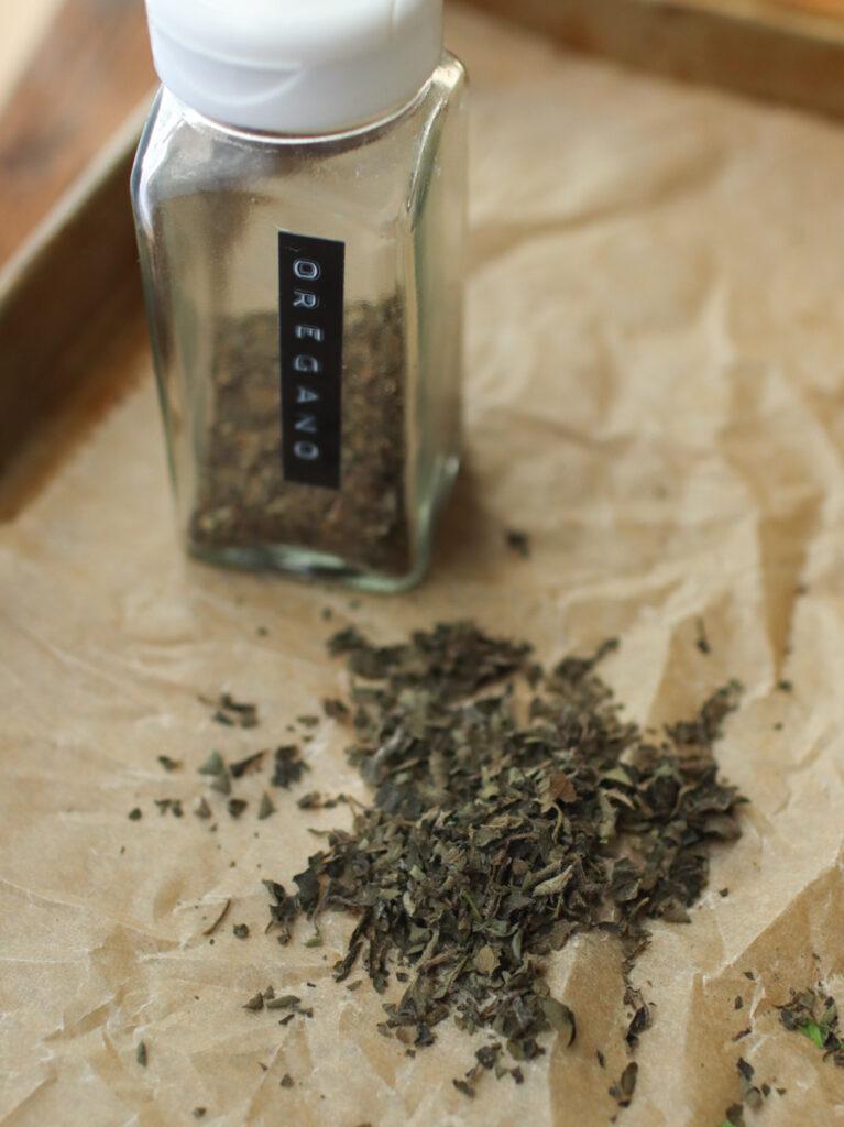 dried oregano with a spice jar