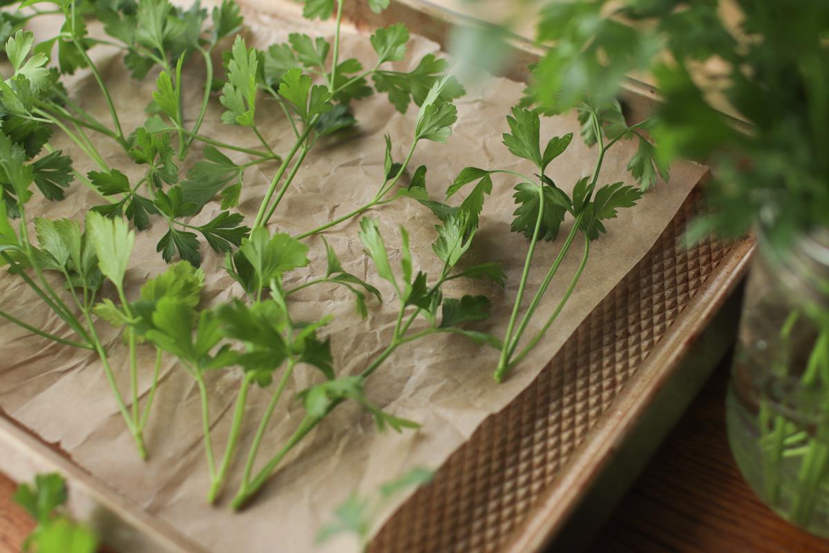 parsley on a parchment paper lined baking sheet