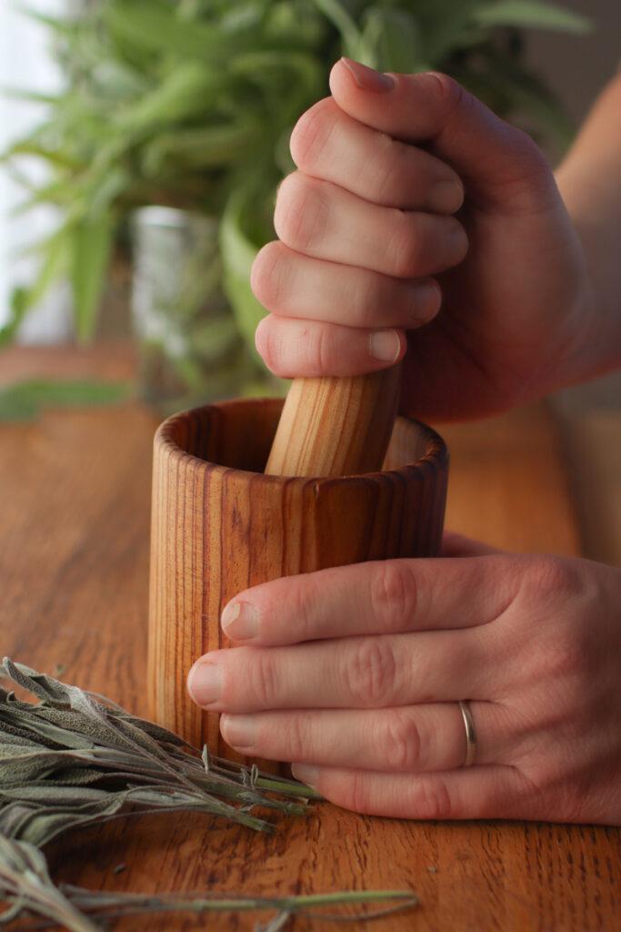 grinding sage with a mortar and pestle