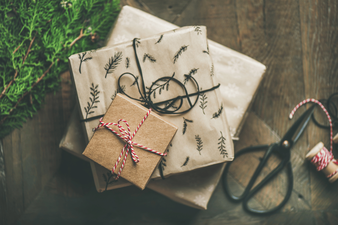 three gifts wrapped with brown paper