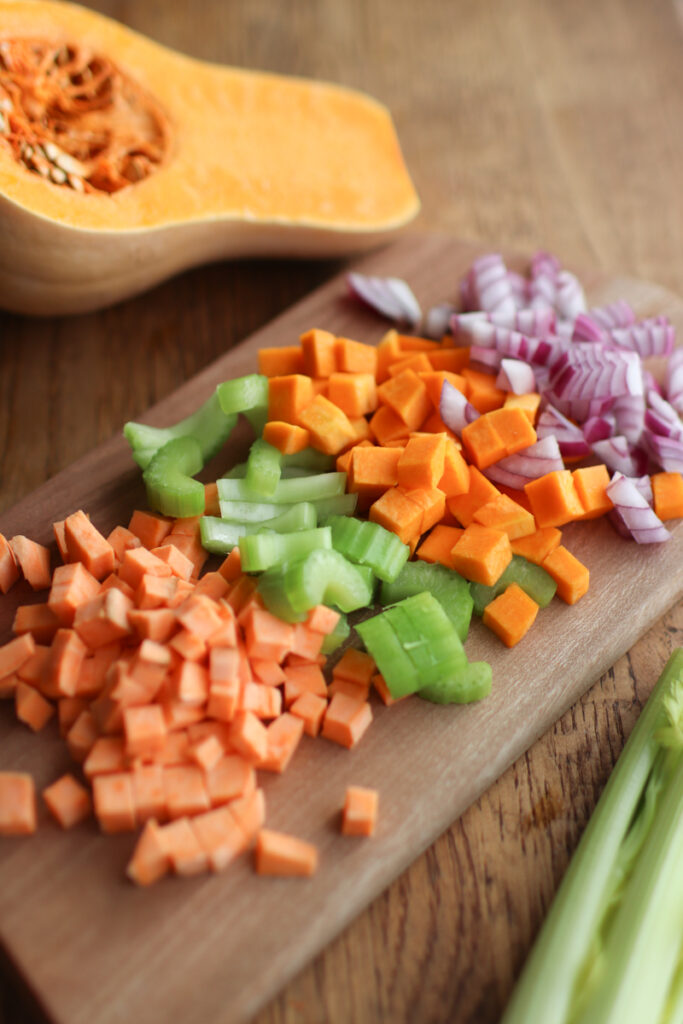 a cutting board with chopped holiday hash ingredients