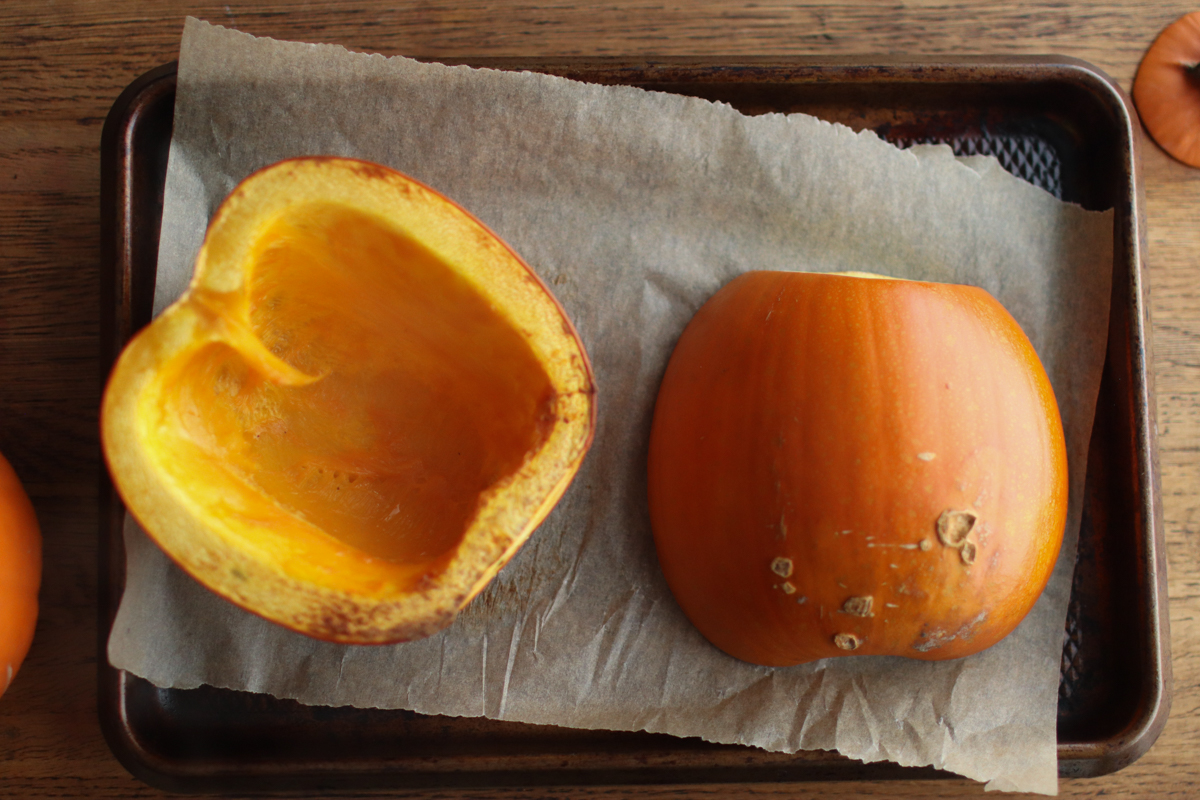 A pumpkin cooked on a baking sheet