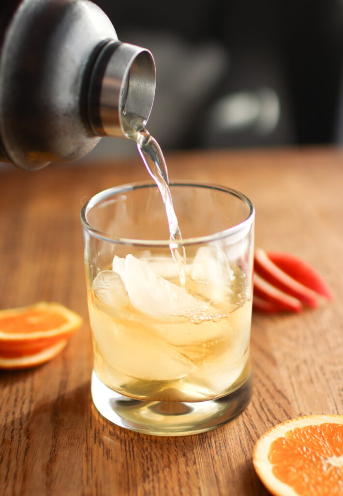 Pouring spiced rum punch into a glass