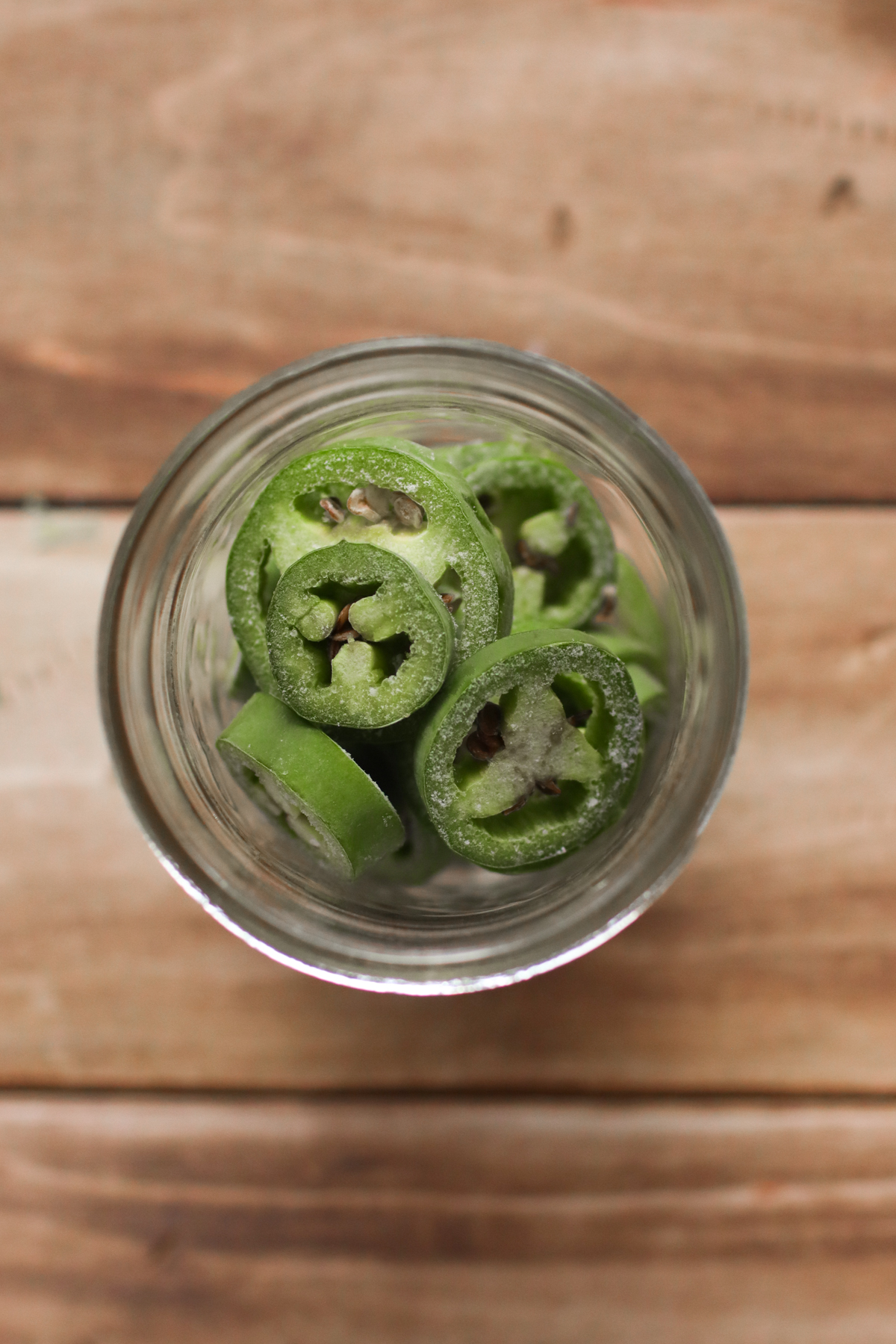 Looking down on a jar of frozen jalapeno slices.