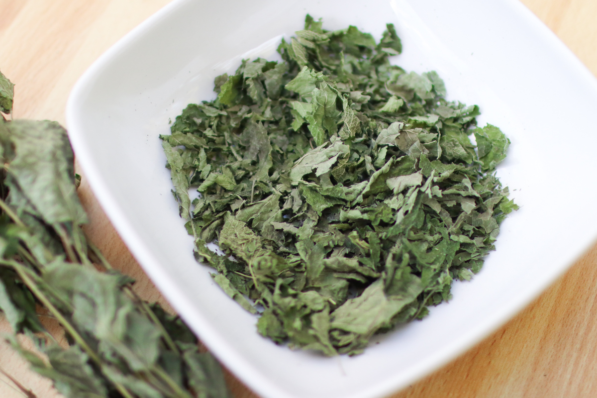A white bowl of dried lemon balm.