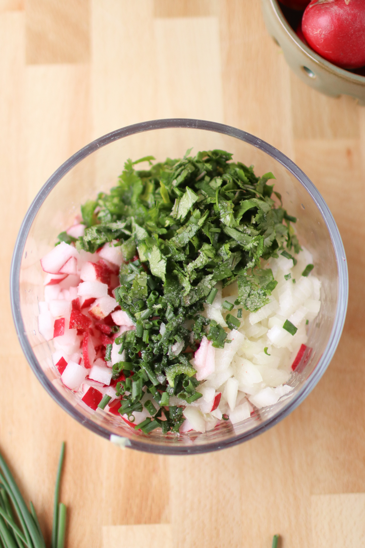 Radish salsa ingredients in a bowl in small piles.