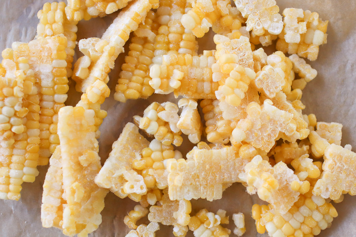 Frozen sweet corn on a piece of parchment paper. 