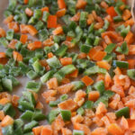 A baking sheet filled with frozen bell peppers.