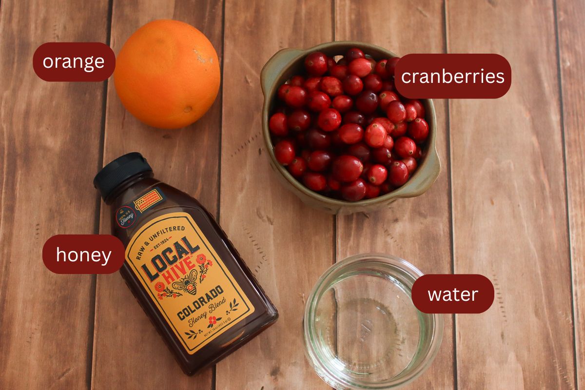 Cranberry sauce ingredients on a wooden table.