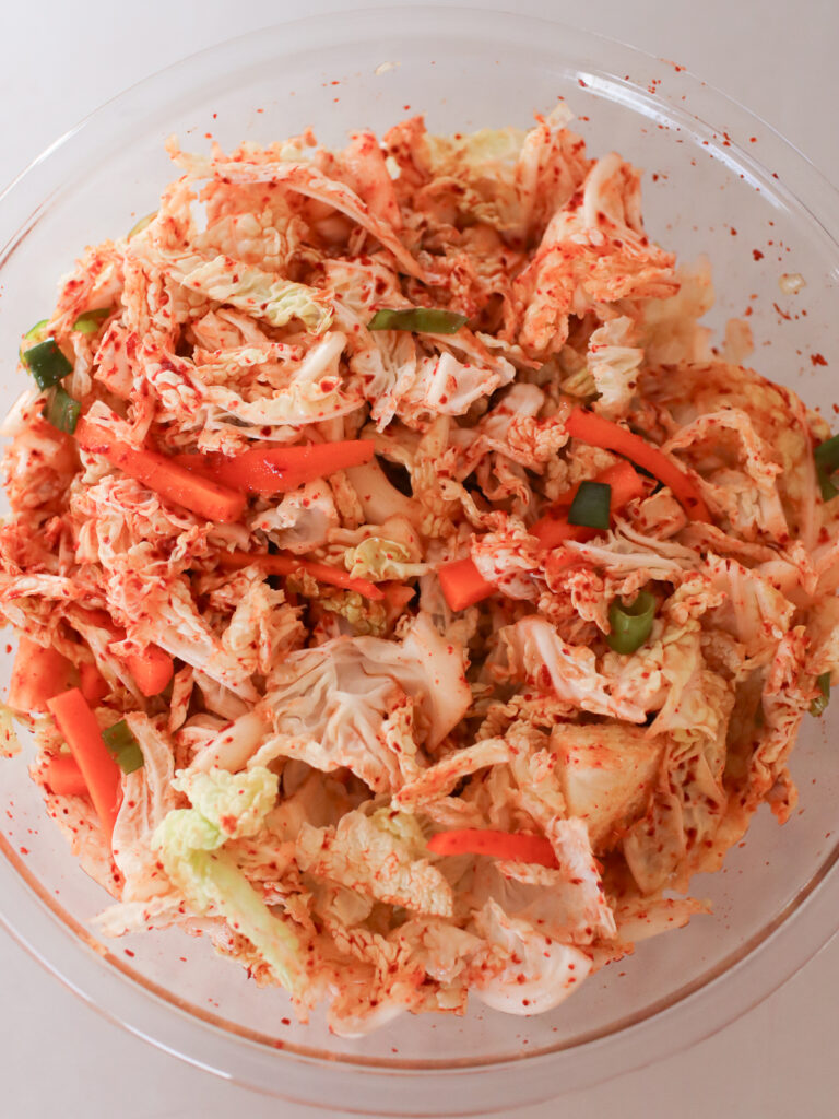 Kimchi ingredients mixed up in a bowl. 